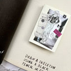 Illustration of a skeleton on a piece of paper with text instructions.