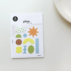Pack of colorful geometric stickers on a white surface