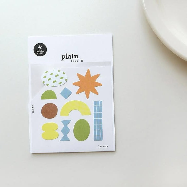 Pack of colourful geometric stickers on a white surface, from the Plain 66 Sticker Sheet
