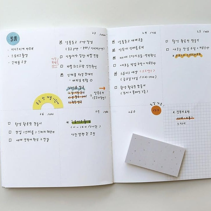 Open notebook with handwritten notes and a small square of paper, from the Plain 67 Sticker Sheet