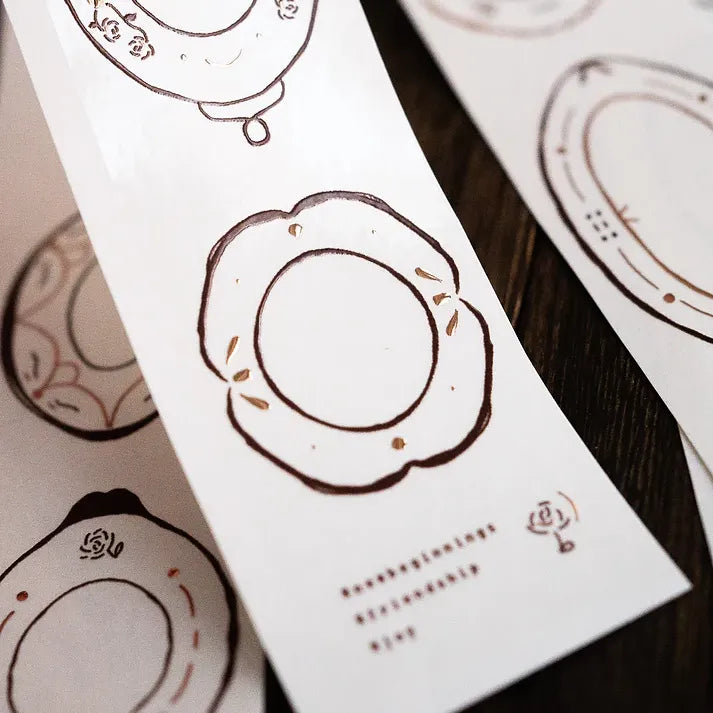 Decorative card layered with an intricate Plates Rose Gold PET Tape motif styled on a wooden surface
