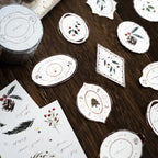 Decorative coasters with floral and nature-themed designs on a wooden surface.