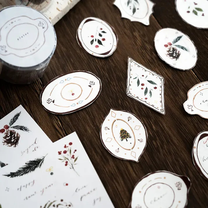 Floral and nature plate designs from the Plates Rose Gold PET Tape styled together on a wooden surface