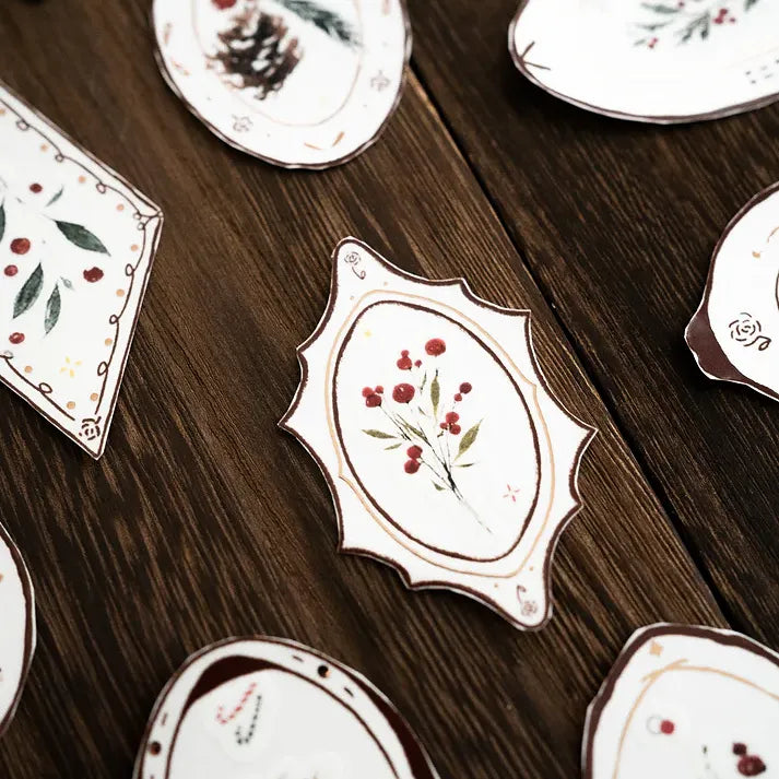 Ornate plate motifs from the Plates Rose Gold PET Tape arranged like fine ceramics on a wooden table