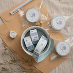 Small containers with labels on a wooden surface