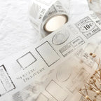 Roll of tape with postage stamp design on a textured surface