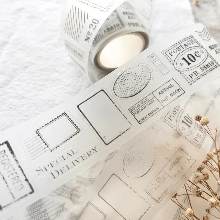 Roll of Posted PET Tape showing its postage stamp print partially unrolled on a textured surface