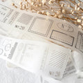 Decorative paper with vintage-style postage stamps and dried flowers on a light background
