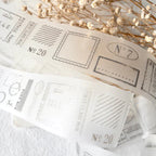 Decorative paper with vintage-style postage stamps and dried flowers on a light background