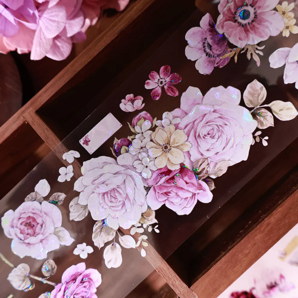 Decorative floral stickers on a glass surface with a wooden frame.