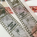 Close-up of a film strip with text and decorative elements on a white background