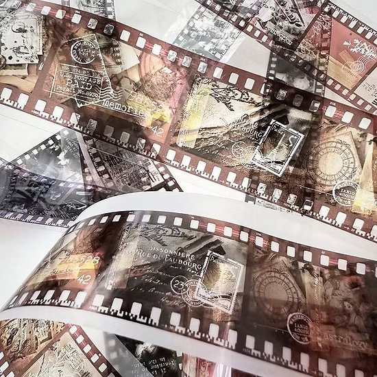 Close-up of a roll of vintage-style film with decorative stamps and text.
