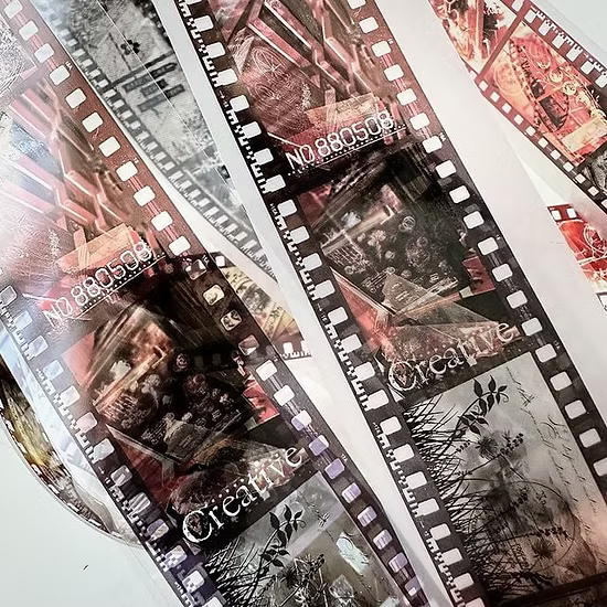 Close-up of a film strip with 'Creative' text and images.