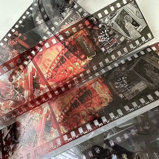 Collection of tarot cards with a film strip design on a reflective surface