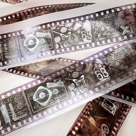 Film strip with black and white images and text on a white background