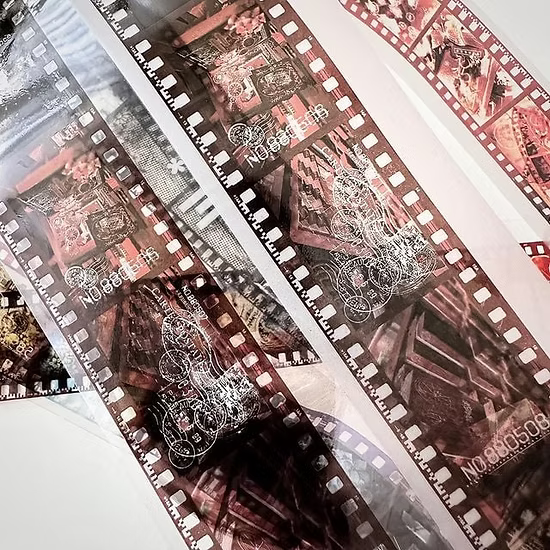 Close-up of a film strip with vintage camera designs.