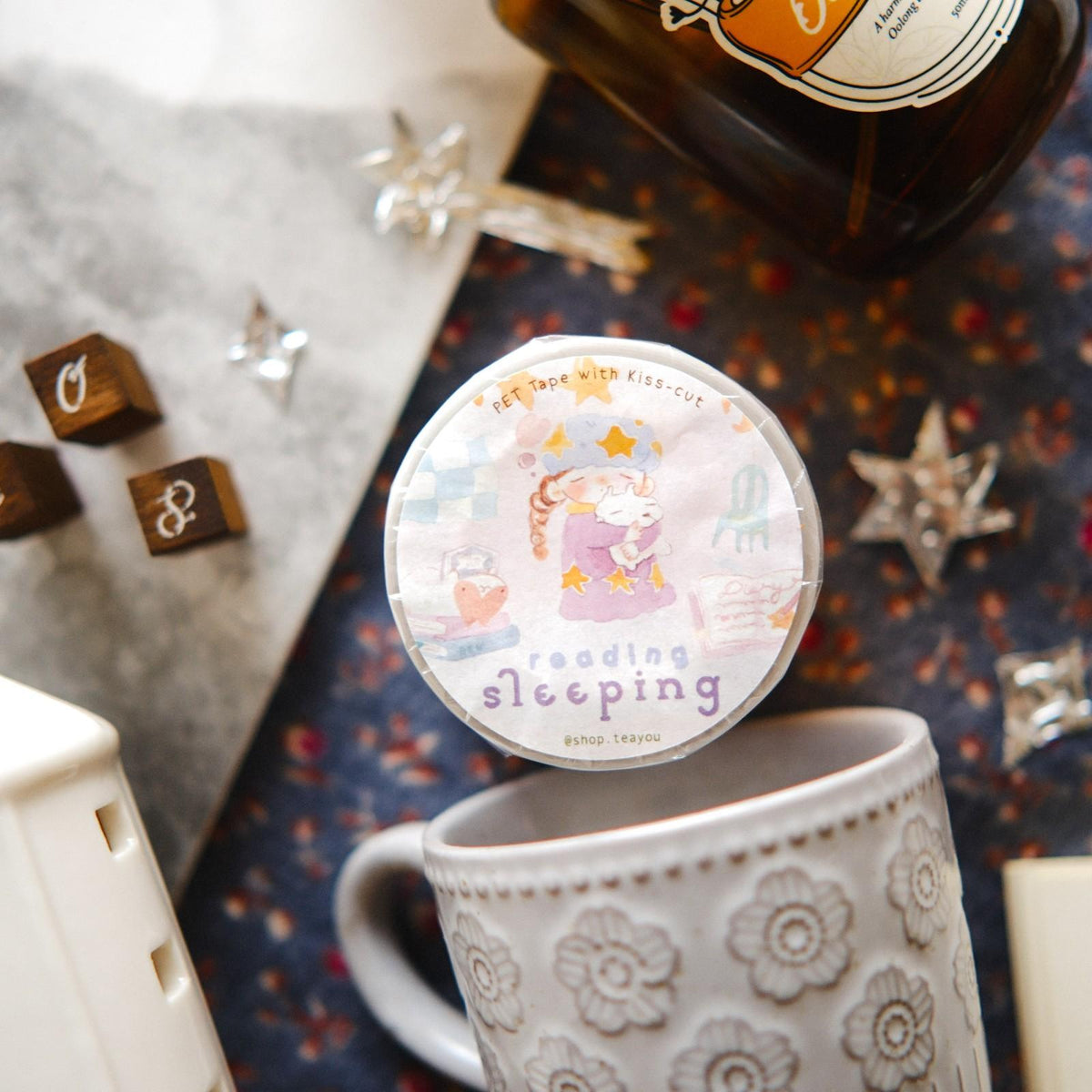 Round sticker with cartoon design on a mug against a patterned background