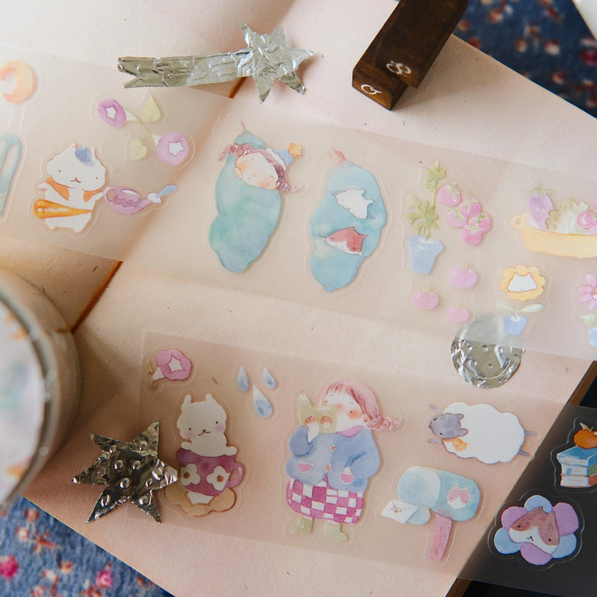Sheet of colorful stickers with cartoon characters on a pink background