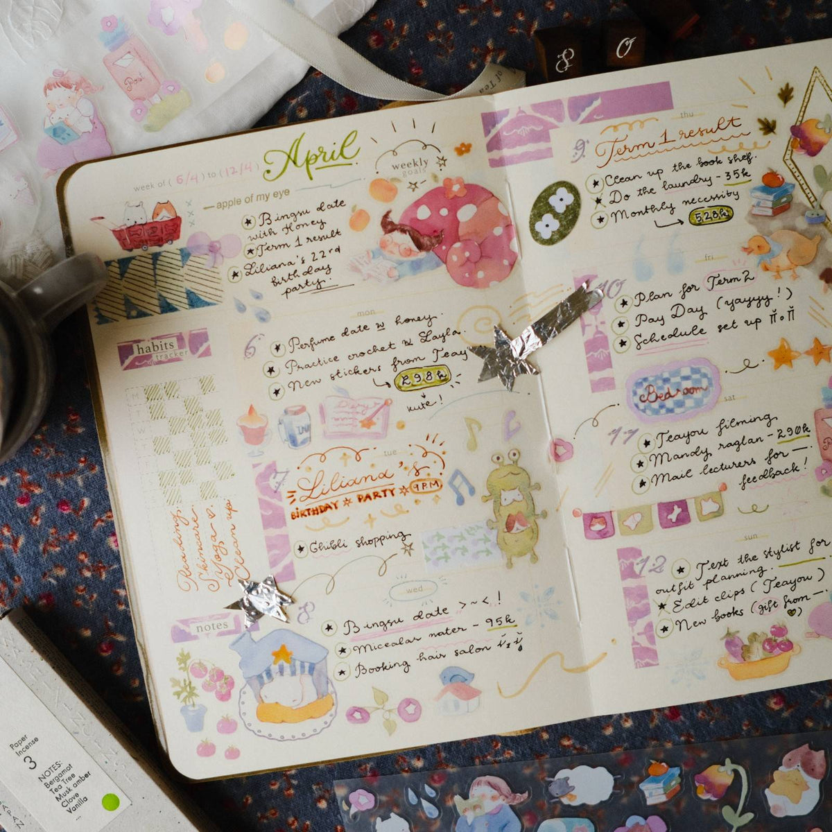 Planner with colorful stickers and text on a patterned surface
