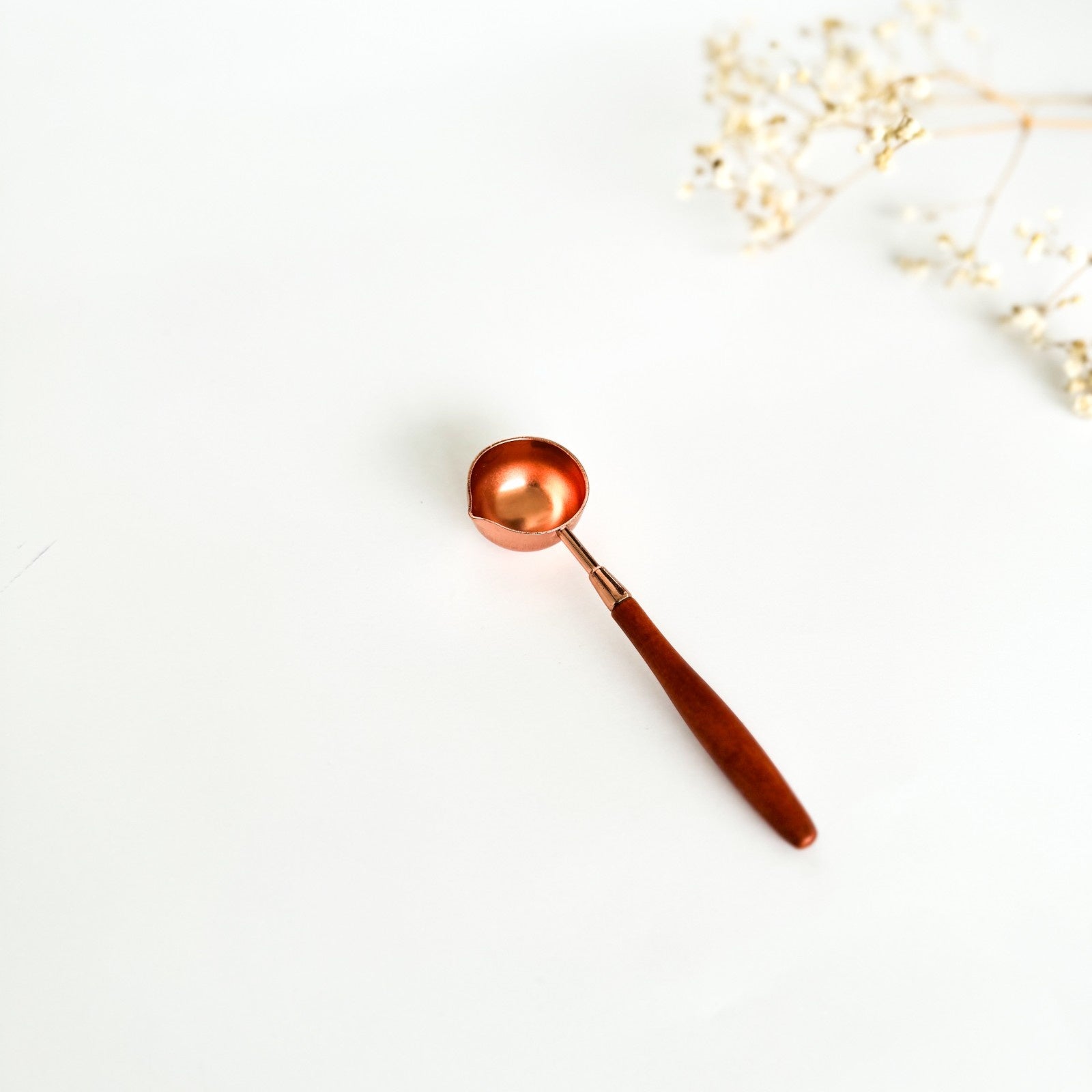 Copper spoon on a white background