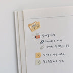 Notebook page with stickers and text on a white background