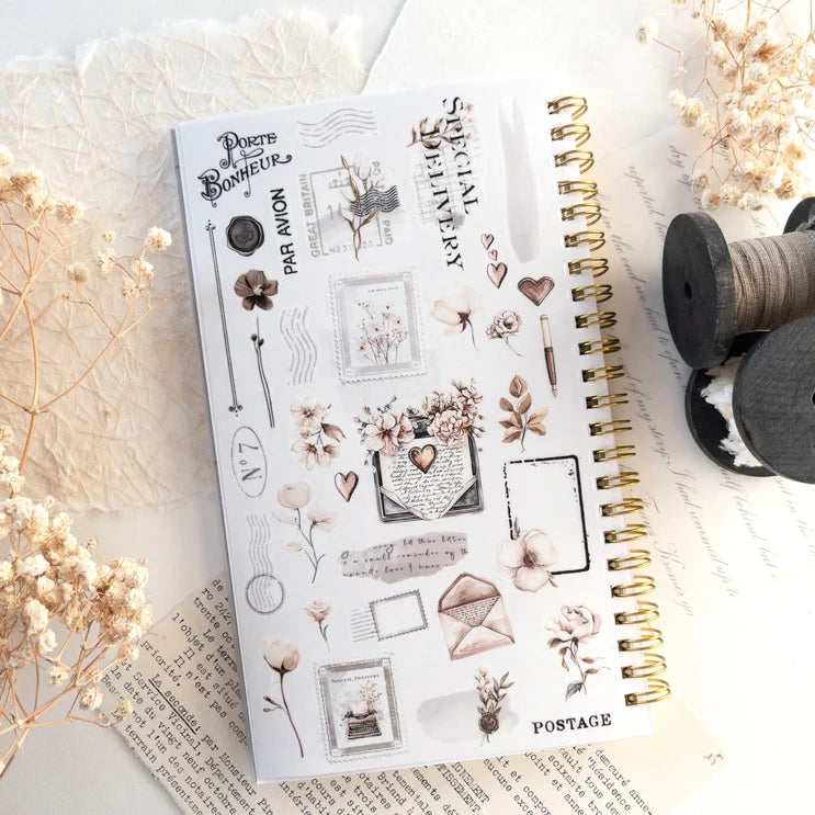 Open Reusable Sticker Storage Book page of floral vintage planner stickers on white