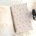 Notebook with floral pattern on a light background