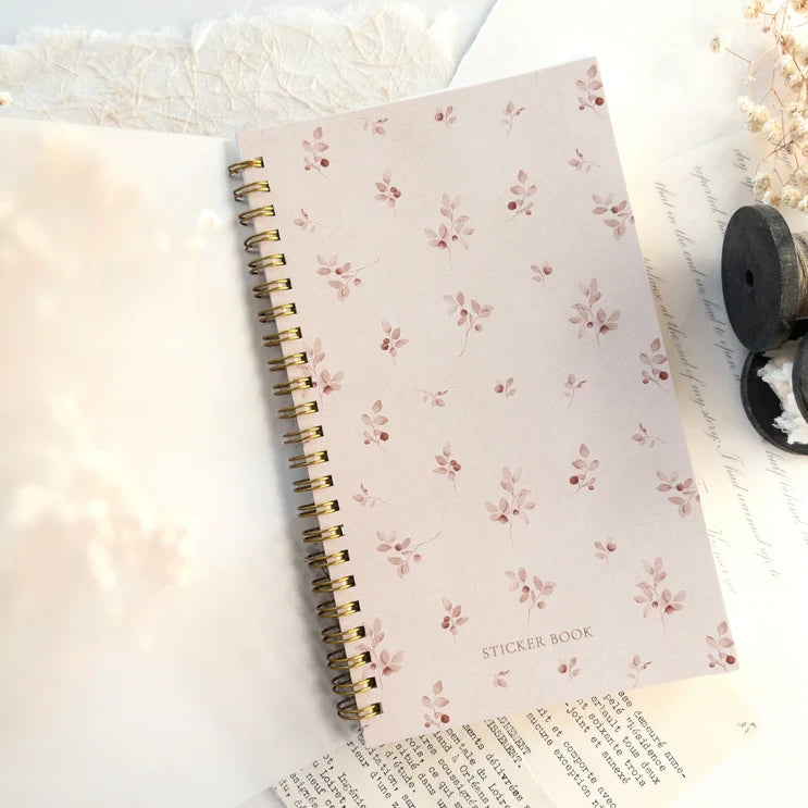 Closed Reusable Sticker Storage Book showing its floral pattern cover on a light backdrop