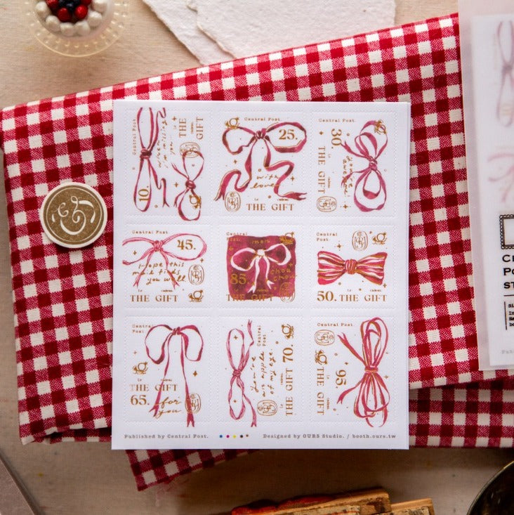 Ribbon Bow Stamp Sticker Sheet by OURS Studio — red-ribbon-and-numbers stamp stickers on checked cloth, for journaling