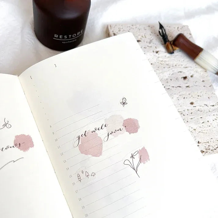 Rose Calligraphy Spiritual Quote PET Tape florals on a notebook with a bottle on a textured backdrop