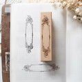 Decorative rubber stamp on a notebook with floral elements