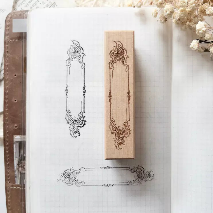 Baroque Frame Rubber Stamp from the French Romance Collection on a notebook with florals