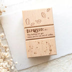 Wooden box with 'Depresso' definition and coffee bean design on a light background