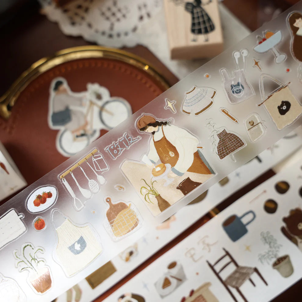 Roll of Salty Lifestyle PET Tape with playful illustrations resting on a wooden surface