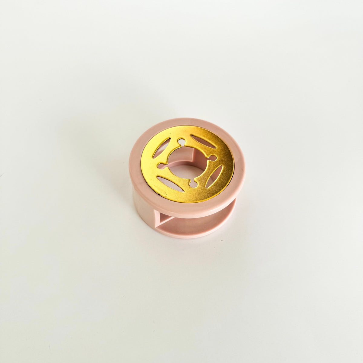 Brass heating plate components of the Light Purple Sealing Wax Furnace on light grey