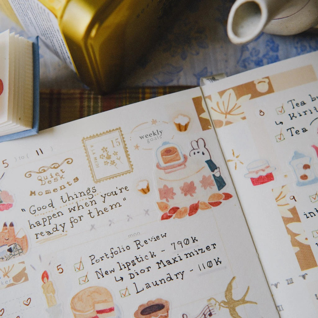 Two notebooks with decorative pages and text on a table.