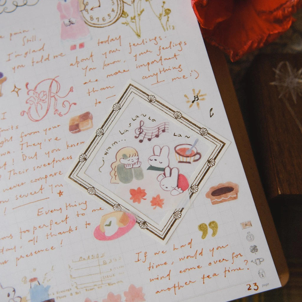 Letter with decorative elements and illustrations on a wooden surface