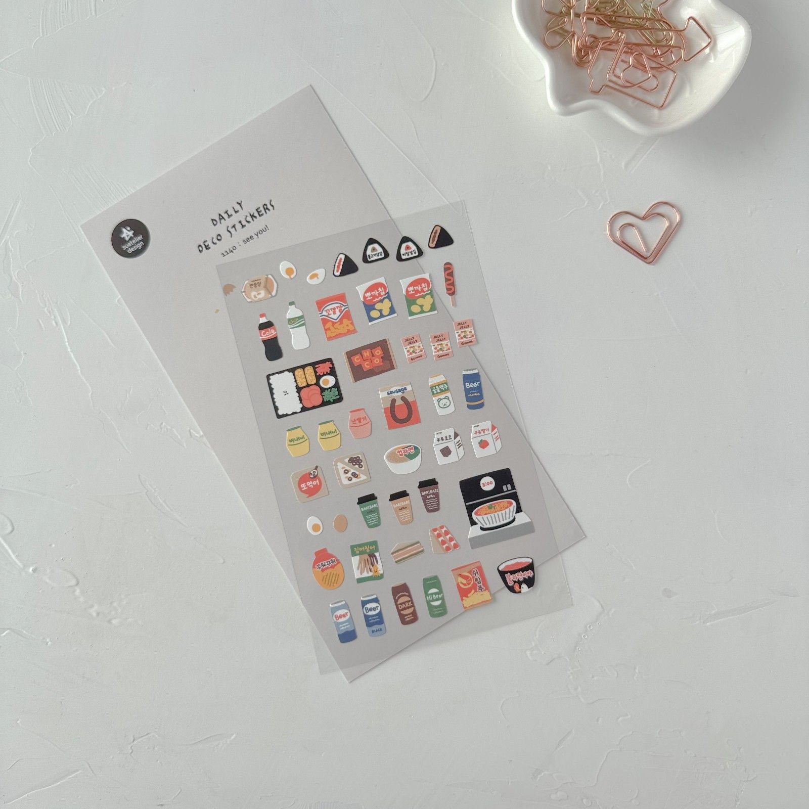 Sheet of small stickers with various icons on a white surface