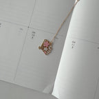 Necklace with a heart-shaped pendant on a calendar page