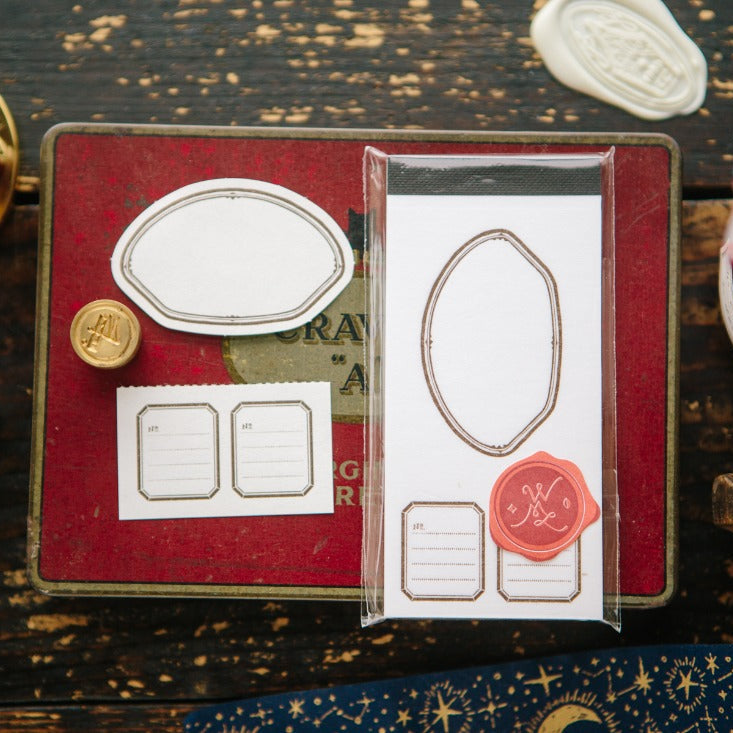 Shell Label Letterpress Memo Pad by OURS Studio styled with stamps and seals on rustic wood