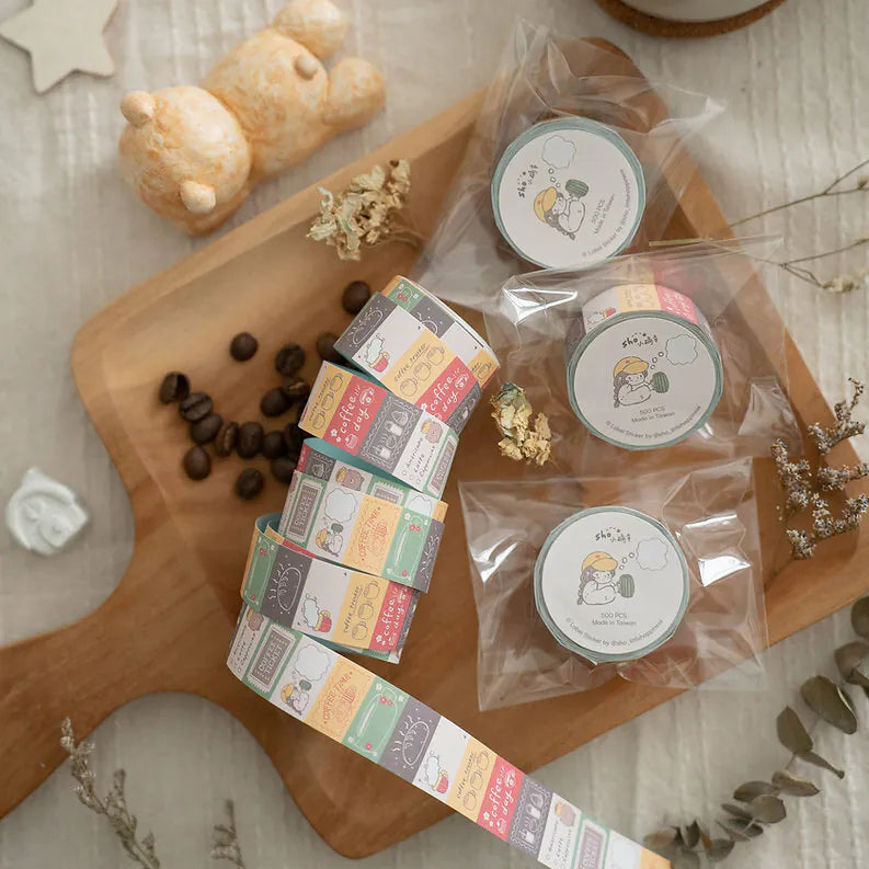 Coffee Label Sticker Tape rolls on a wooden board styled with coffee beans and a teddy bear