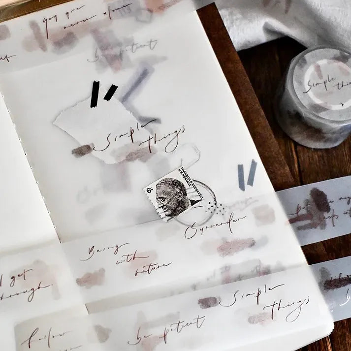 Simple Things PET Tape styled on printed paper with a postage stamp on a warm wooden surface