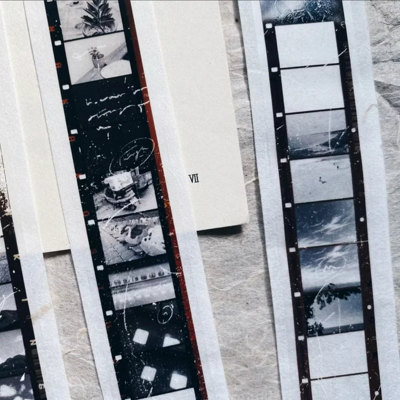 Close-up of Skyline PET Tape vintage film negatives and prints on a textured surface