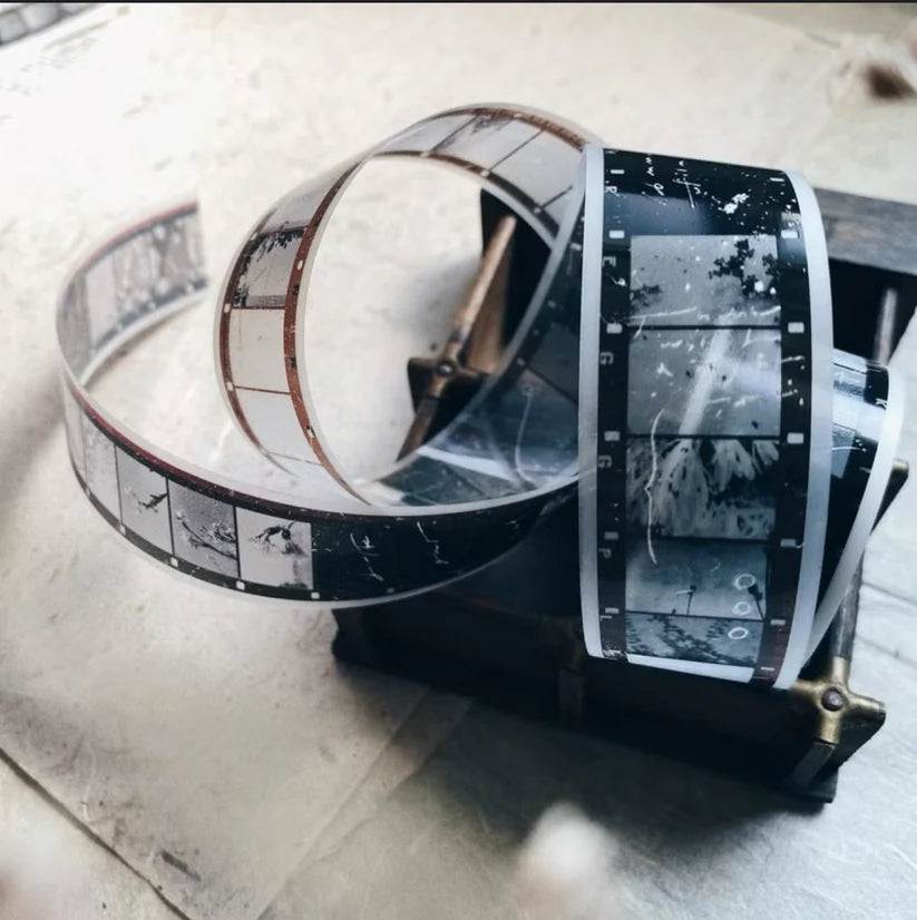 Skyline PET Tape styled with a film reel and monochrome strip on a wooden surface