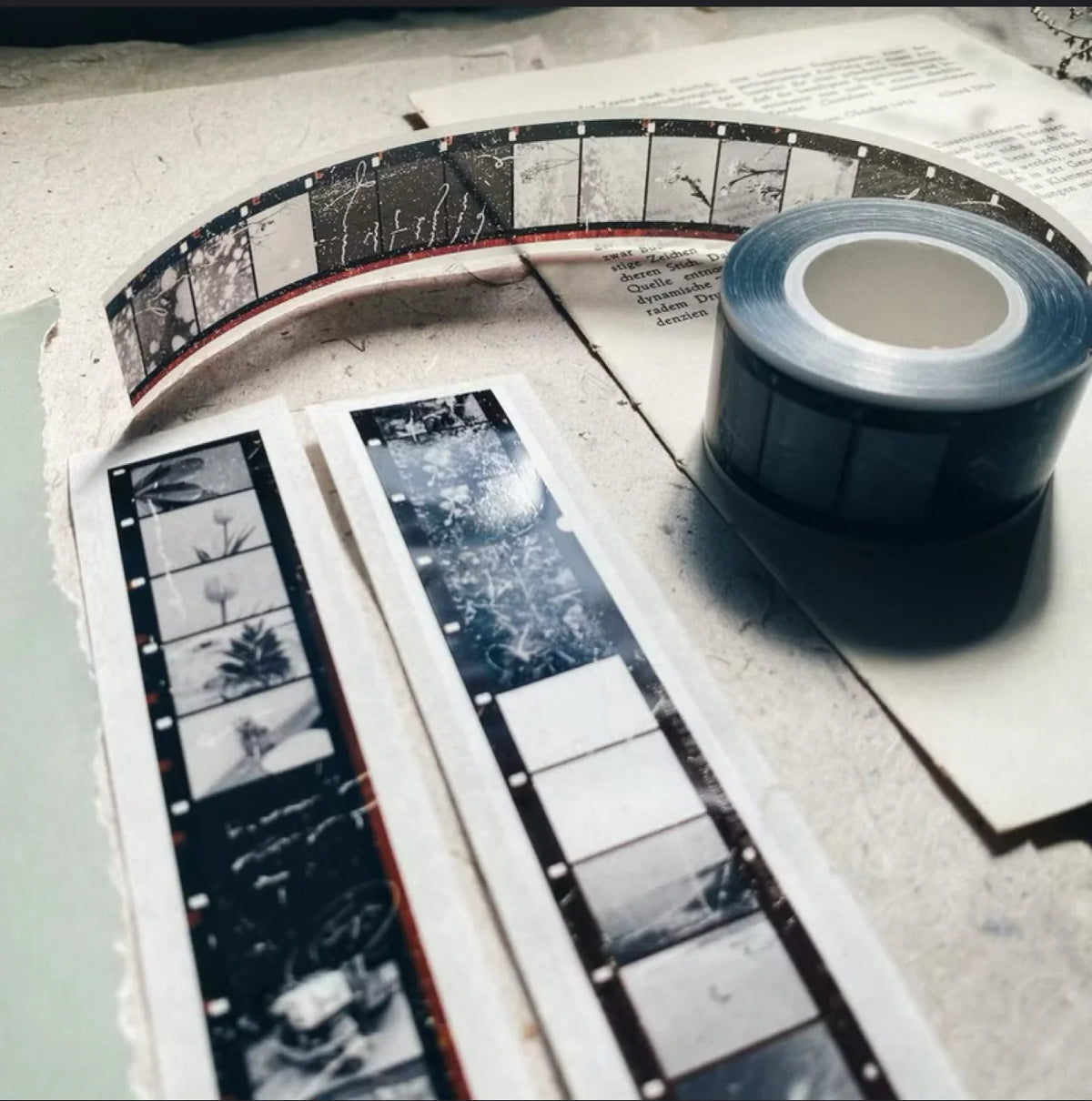 Skyline PET Tape film strips and a roll of black tape arranged on a textured surface