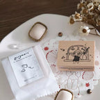 Wooden stamp with design and packaging on a decorative plate with flowers