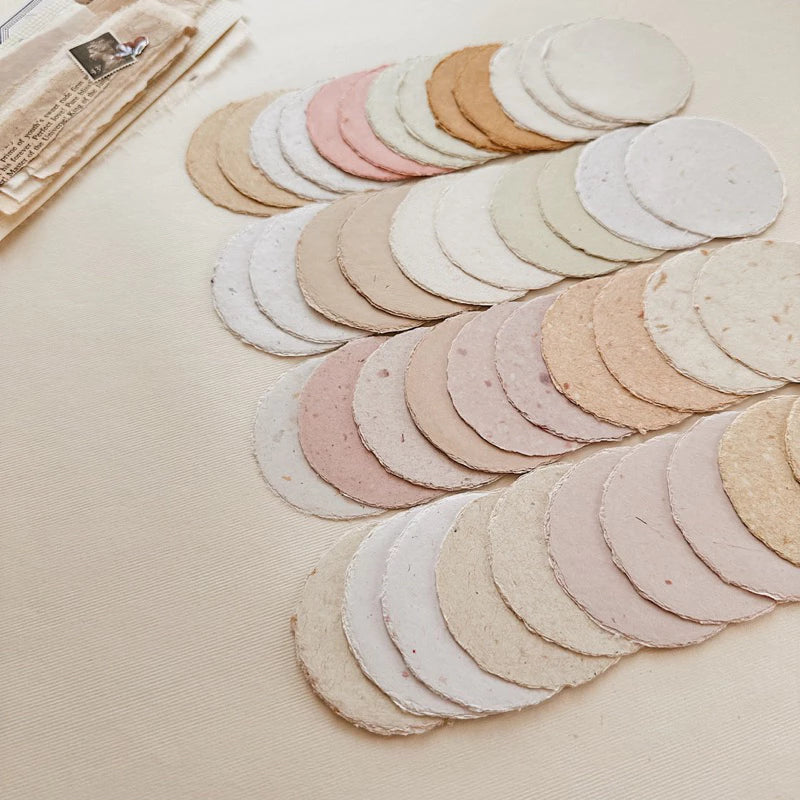 Small Circle Handmade Paper rounds arranged in a pattern on a light surface, styled detail view