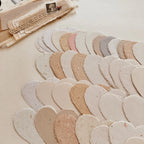 Collection of heart-shaped cutouts in various earthy tones on a textured surface.