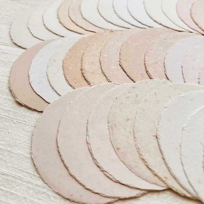 Small Moon Handmade Paper paper pieces in soft beige stacked on a textured surface