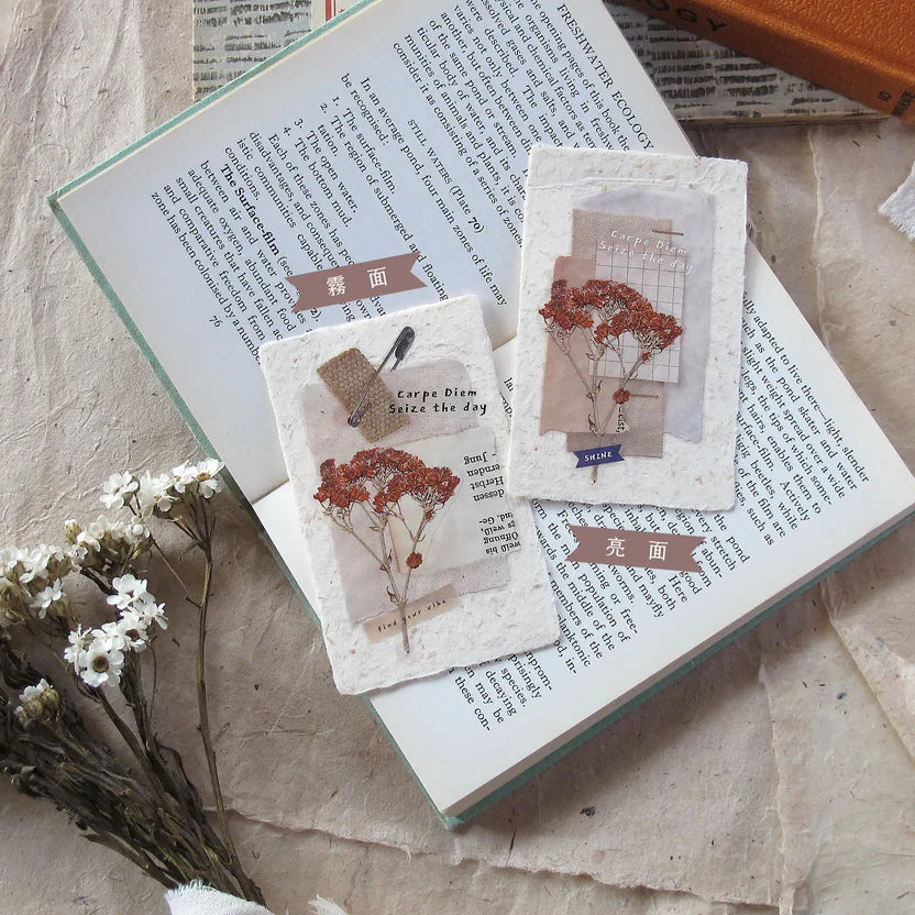 Three Snippets Chapter 2 PET Tape floral card designs resting on an open book, top view